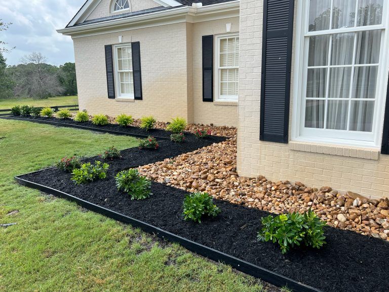 bull rock border around house, black mulch with landscape border, modern landscape, bryan residential landscapes