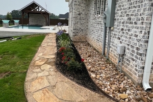 crushed granite with flagstone steps, bull rock drainage, agapanthus, custom landscape