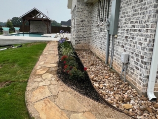 crushed granite with flagstone steps, bull rock drainage, agapanthus, custom landscape